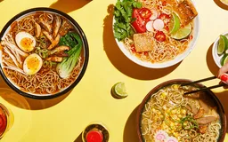 Bowls of immi ramen on a yellow table