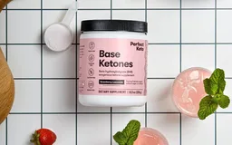 A tub of Perfect Keto Base Ketones on a tiled kitchen counter