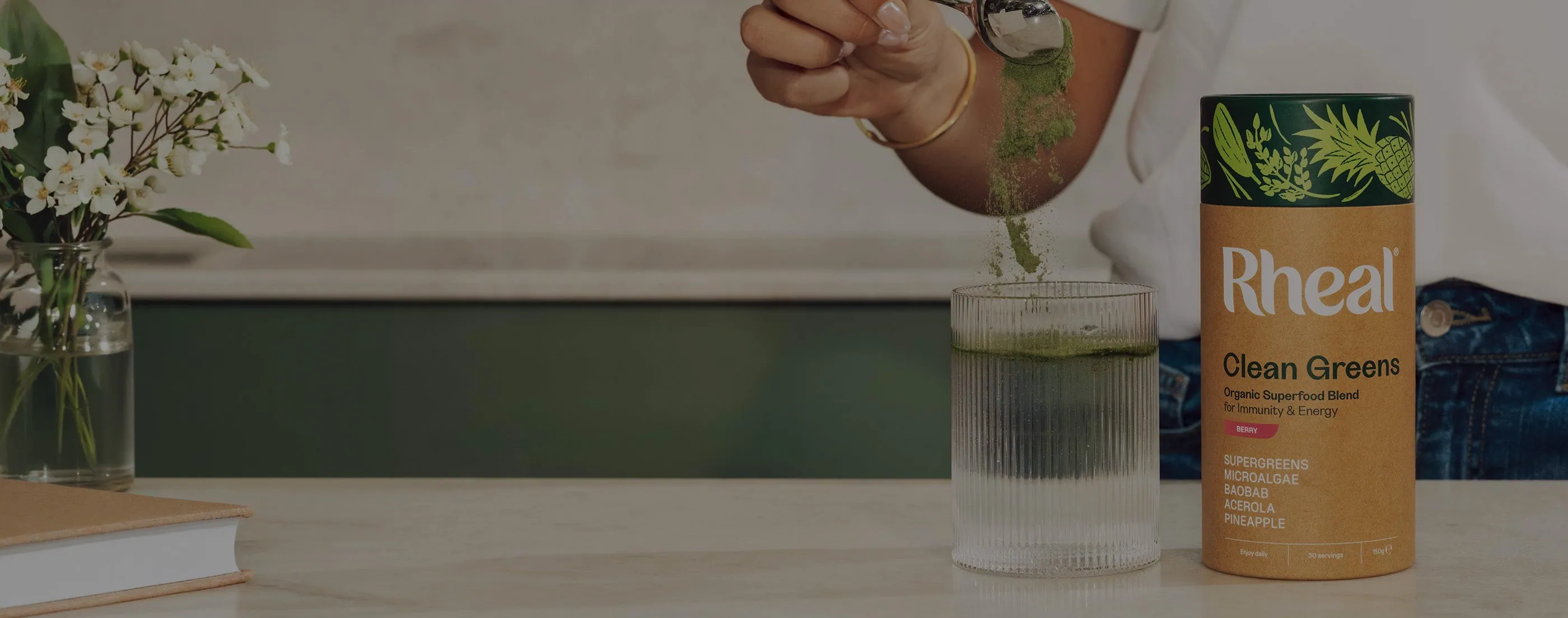 Clean Greens being scooped into a glass